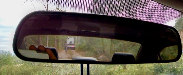 semi truck in rearview mirror